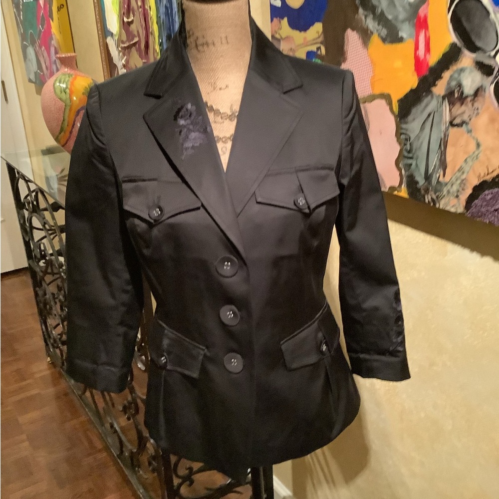 Black blazer with embroidered design.
